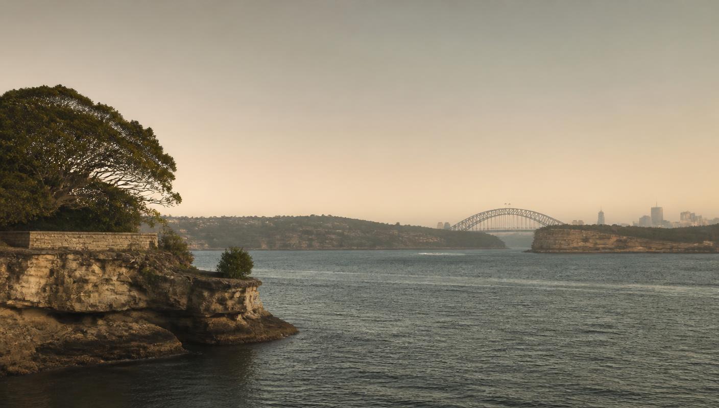 A quiet Australian headland at dawn with low mist over still water